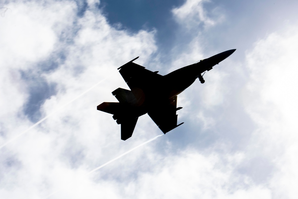 F/A-18E Super Hornet Flies Over Flight Deck