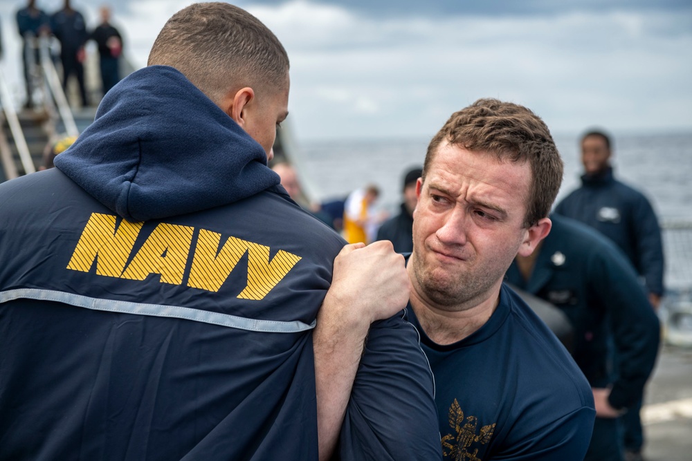 Sonar Technician (Surface) 3rd Class Joseph Brown, right, from Providence, R.I., participates in the sentry Oleoresin Capsaicin (OC) practical course