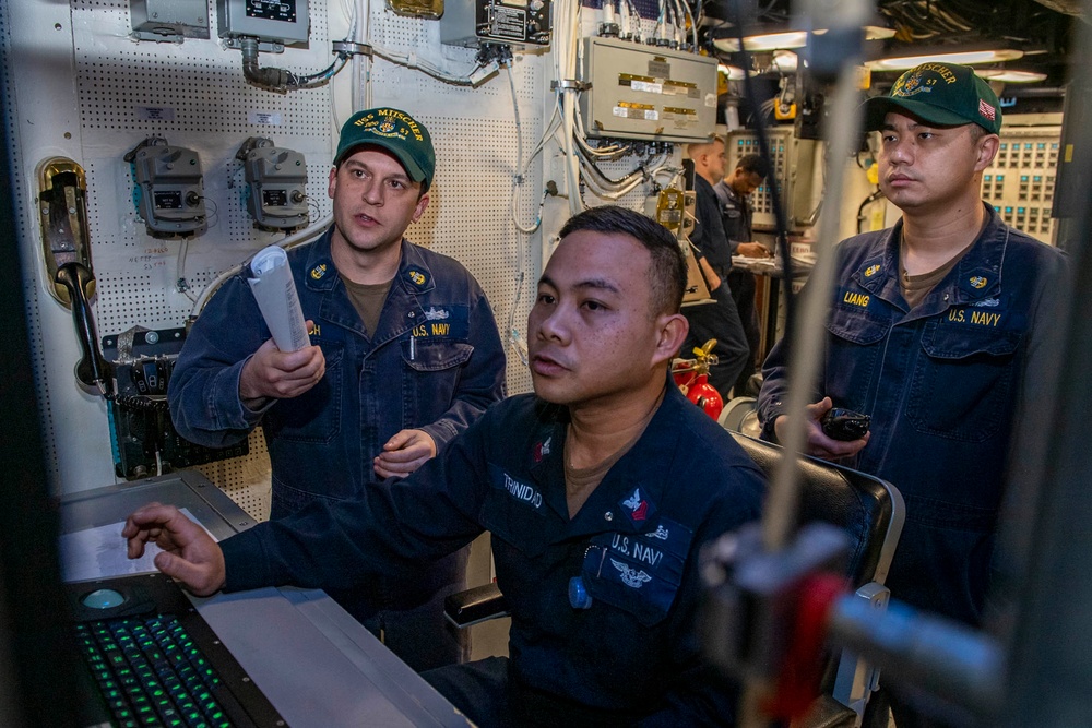 Chief Electrician’s Mate Jay Bosch, left, from Rochester, N.Y., Electricians Mate 1st Class Winston Trinidad, center, from Manila, Philippines, and Chief Gas Turbine Systems Technician (Mechanical) Hong Liang, from Cary, N.C., review casualty alarms.