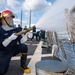 Machinist Mate 3rd Class Andrew Harney, from Bend, Ore., stands as the nozzleman of a hose team during a firefighting drill