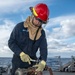 Gas Turbine Systems Technician (Mechanical) Fireman Gage Burton, from Kyle, Texas, patches a pipe during a firefighting drill