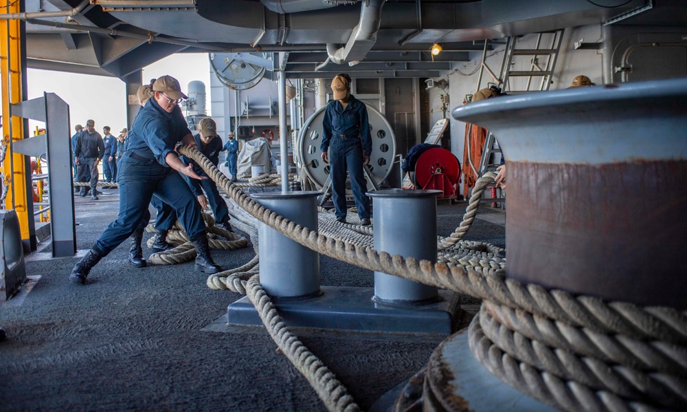 Sailors Heave Into A Mooring Line