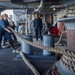 Sailors Heave Into A Mooring Line