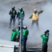 Sailors Direct Jet On The Flight Deck