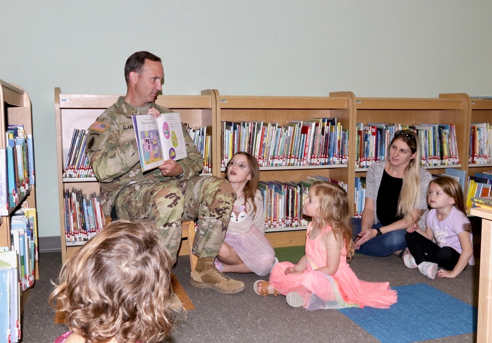 Col. Jason Clarke reads to children