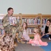 Col. Jason Clarke reads to children