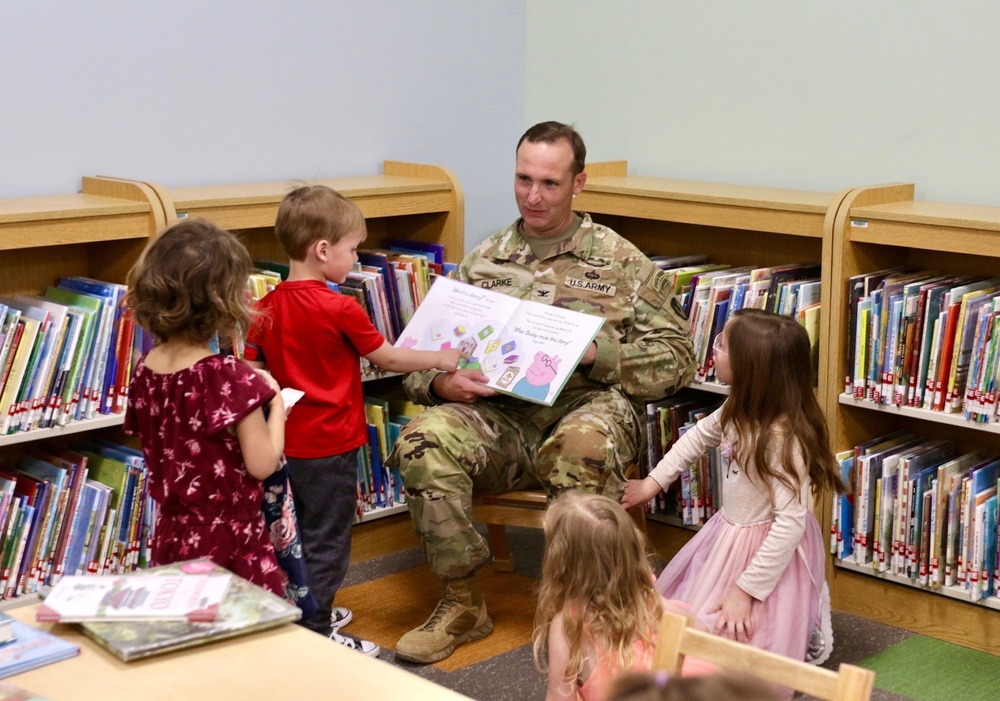 Col. Jason Clarke reads to children