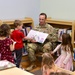 Col. Jason Clarke reads to children