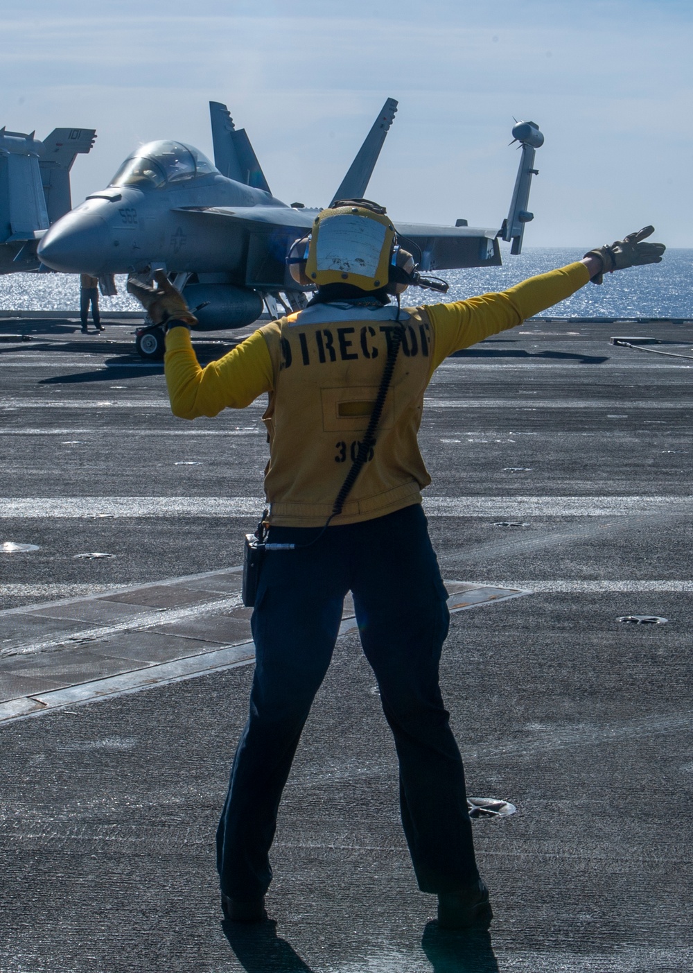 Sailor Directs An Aircraft