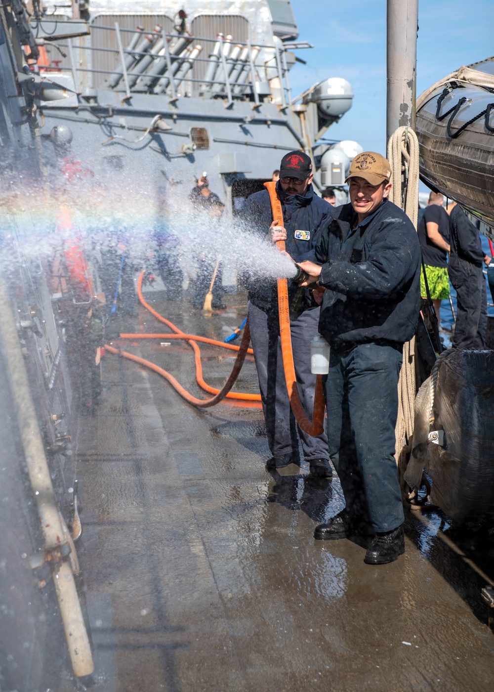 Boatswain’s Mate 3rd Class Roberto Cardenasguillen, from Fontana, Calif., sprays the hull during a fresh-water washdown