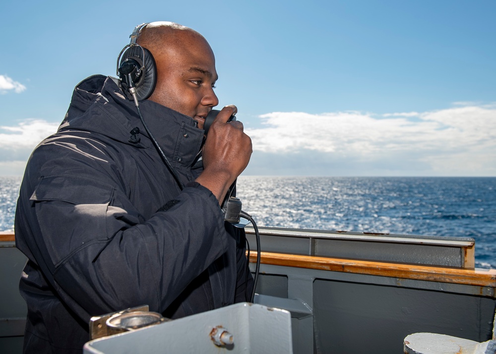 Boatswain’s Mate 1st Class Tonio James, from Brooklyn, N.Y., conducts a sound-powered phone test on a bridgewing