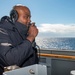 Boatswain’s Mate 1st Class Tonio James, from Brooklyn, N.Y., conducts a sound-powered phone test on a bridgewing