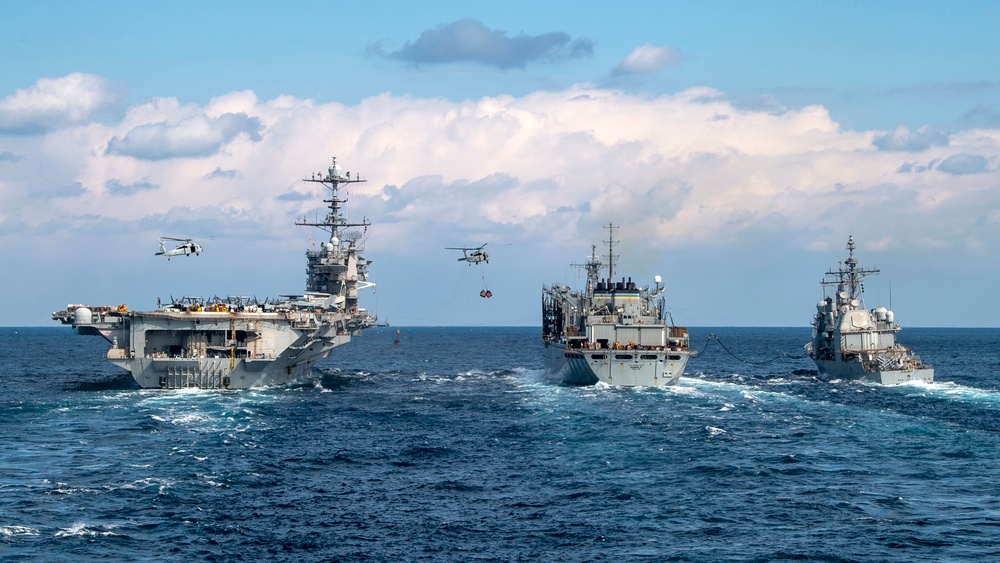 Nimitz-class aircraft carrier USS Harry S. Truman (CVN 75) conducts a vertical replenishment with Supply-class fast combat support ship USNS Supply (T-AOE-6)