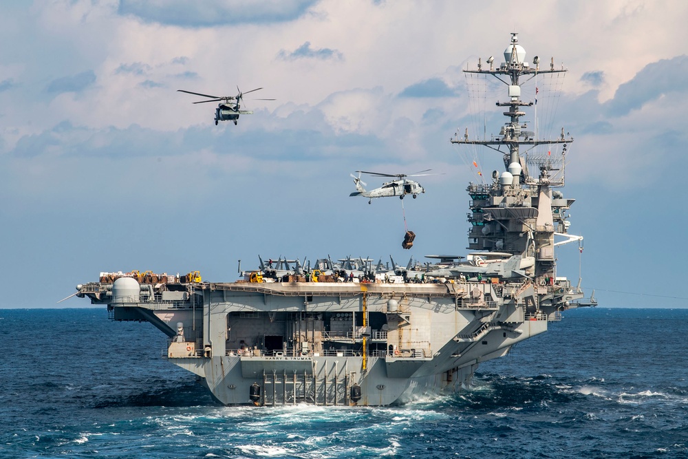 Nimitz-class aircraft carrier USS Harry S. Truman (CVN 75), left, and Arleigh Burke-class guided-missile cruiser USS San Jacinto (CG 56), right, conduct a vertical replenishment and replenishment-at-sea.