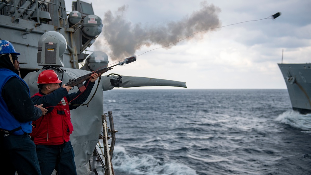 Gunner’s Mate 3rd Class Elvis Chavez, from Paterson, N.J., fires a shot line