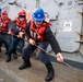 Sailors aboard Arleigh Burke-class guided-missile destroyer USS Mitscher (DDG 57) take in line during a replenishment-at-sea with Supply-class fast combat support ship USNS Supply (T-AOE-6)