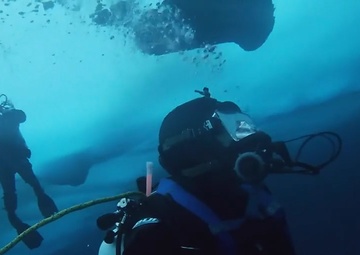 Navy divers plunge under Arctic ice to recover torpedoes