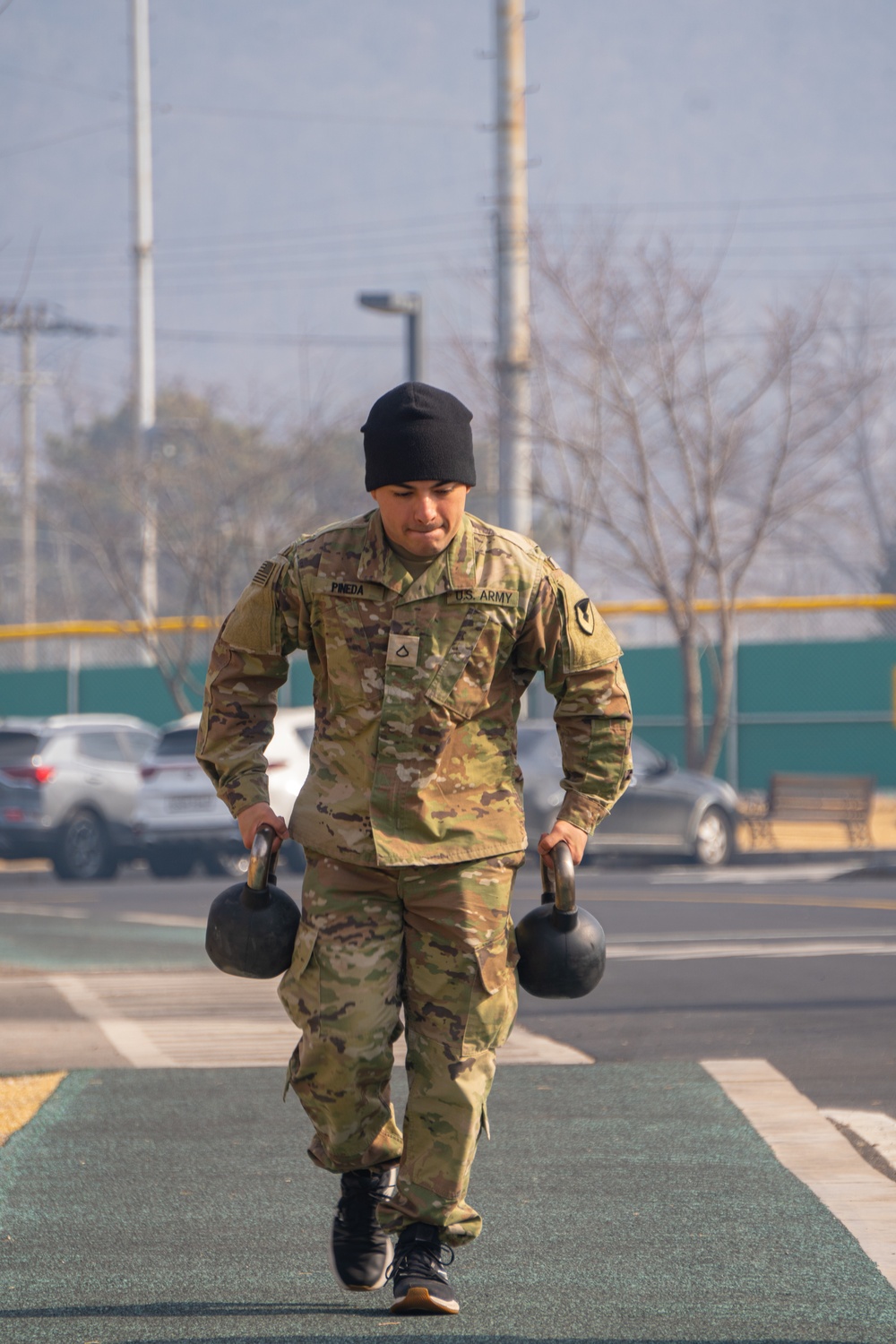 PFC Haniel Pineda carries dumbbells