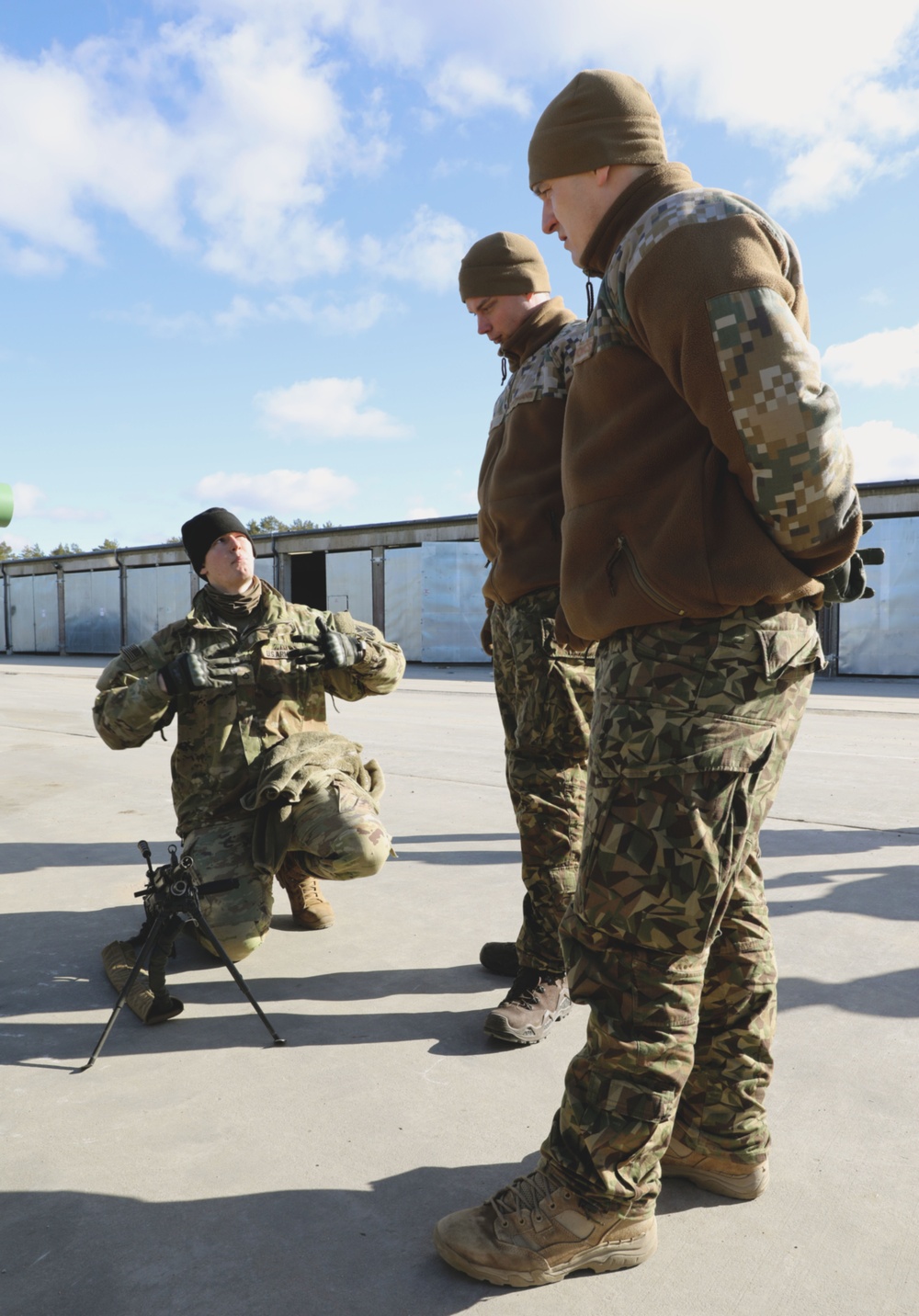 American and Latvian Soldiers build rapport and work together on the M-SHORAD Stryker.