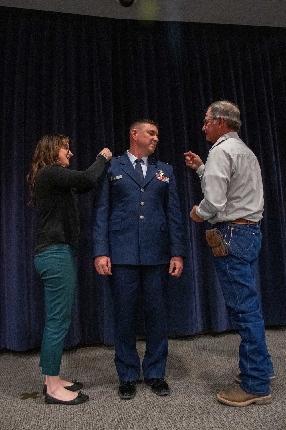 THE PINNING: Maj. Robert Kolvet's wife and father pin his new Lieutenant Colonel rank on his uniform