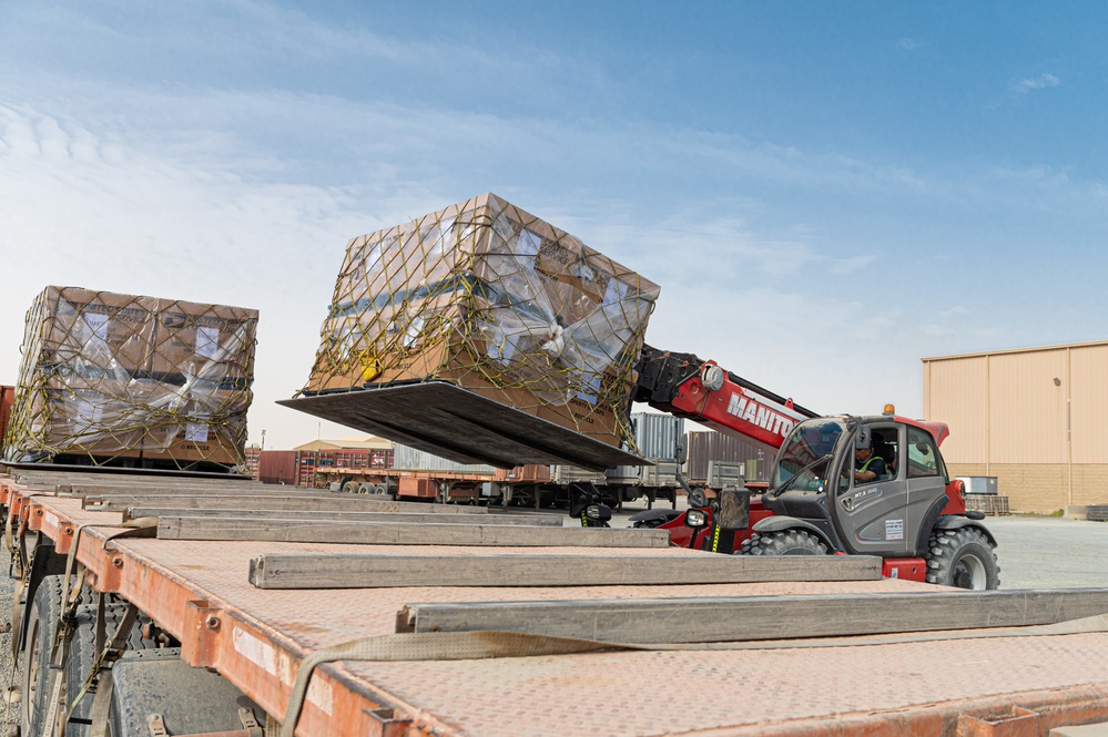 Shipping a piece of home overseas: service members work together to deliver mail