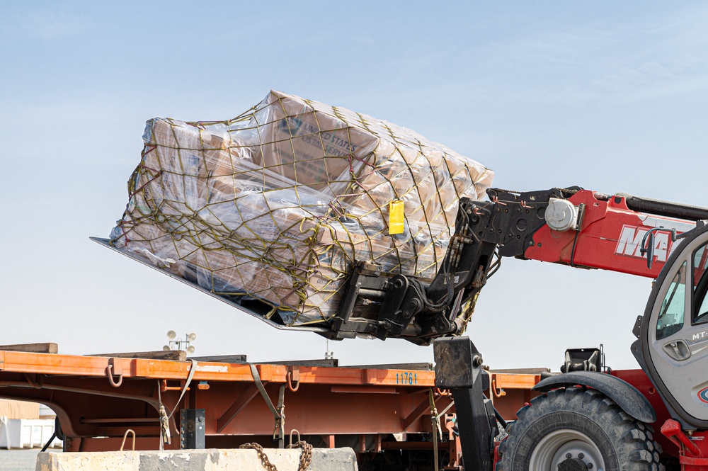 Shipping a piece of home overseas: service members work together to deliver mail