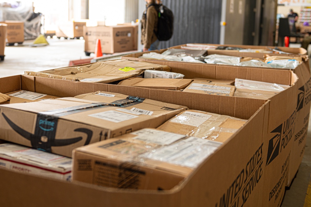 Shipping a piece of home overseas: service members work together to deliver mail