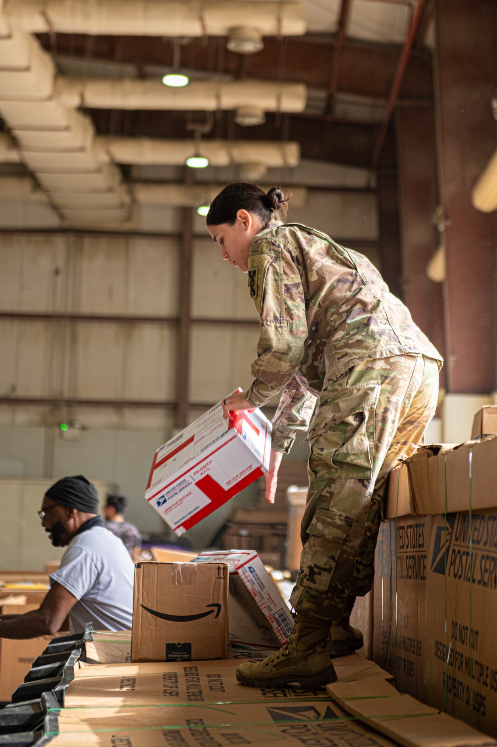 Shipping a piece of home overseas: service members work together to deliver mail