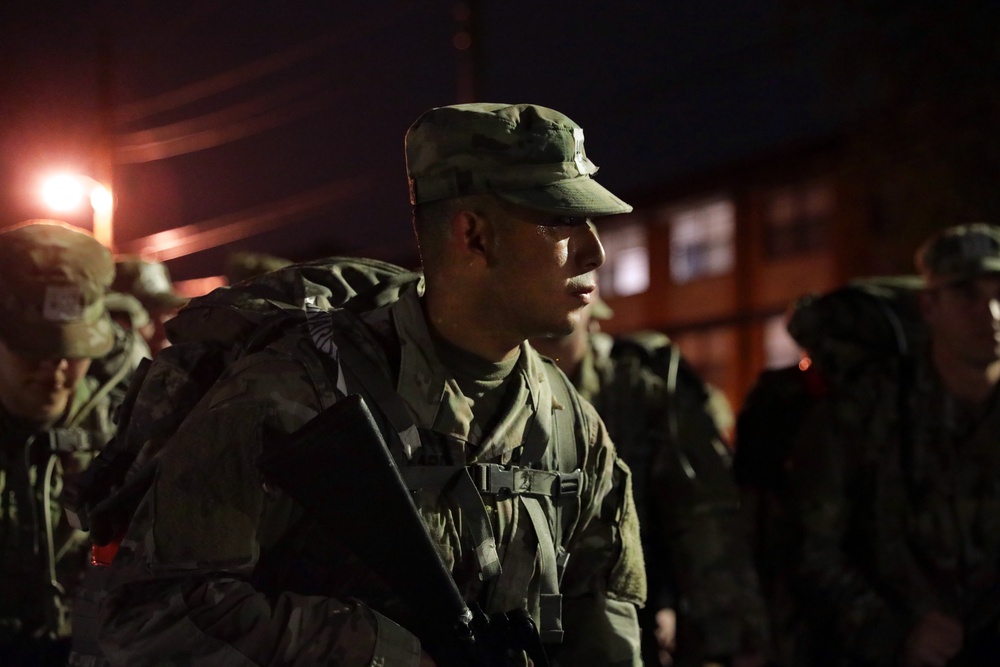 Warrant Officer Candidates step off for ruck march