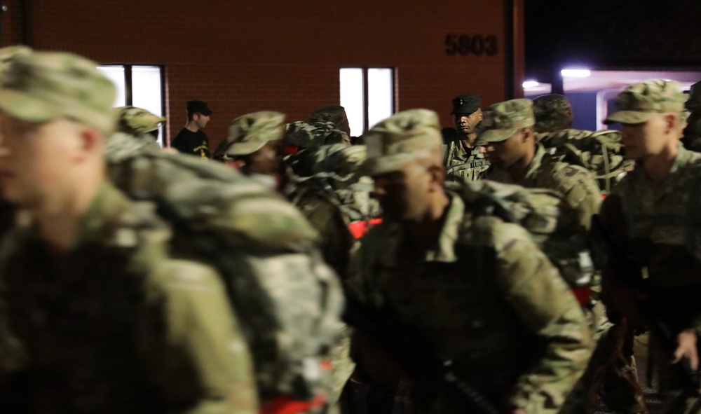Warrant Officer Candidates step off for ruck march