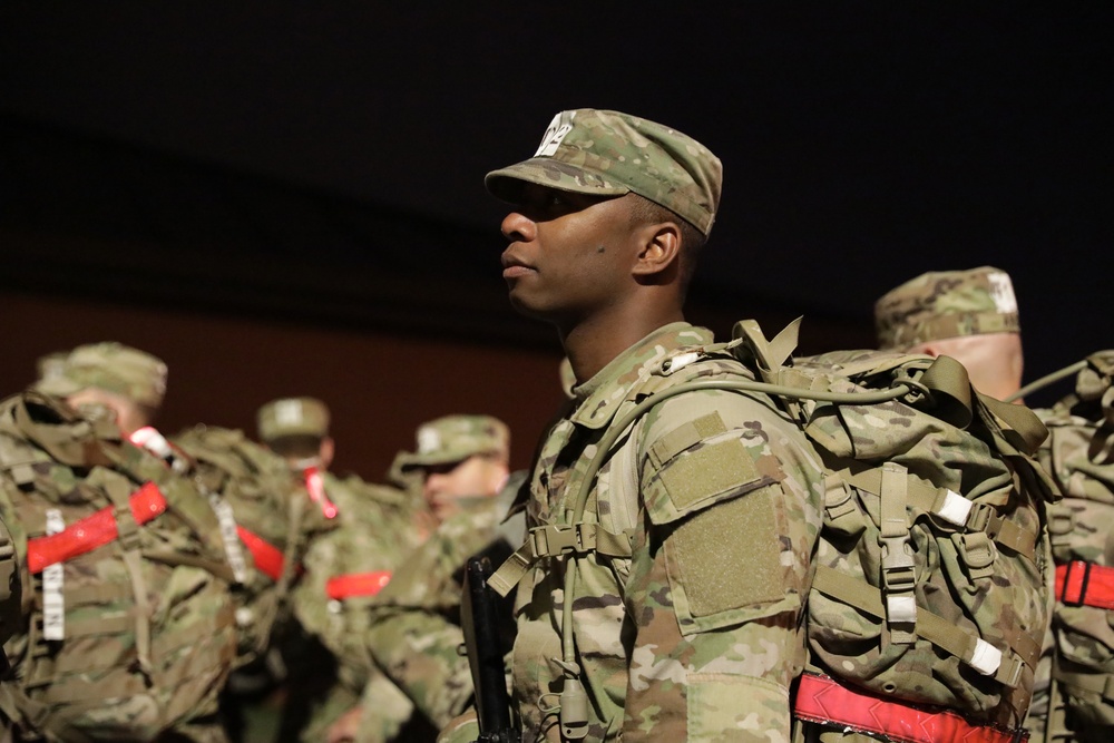 Warrant Officer Candidates step off for ruck march