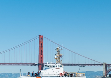 Coast Guard Bay Area assets pose for group photo with a 9/11 commemorative flag