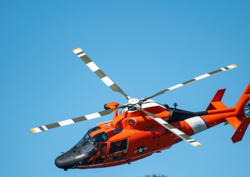 Coast Guard Bay Area assets pose for group photo with a 9/11 commemorative flag