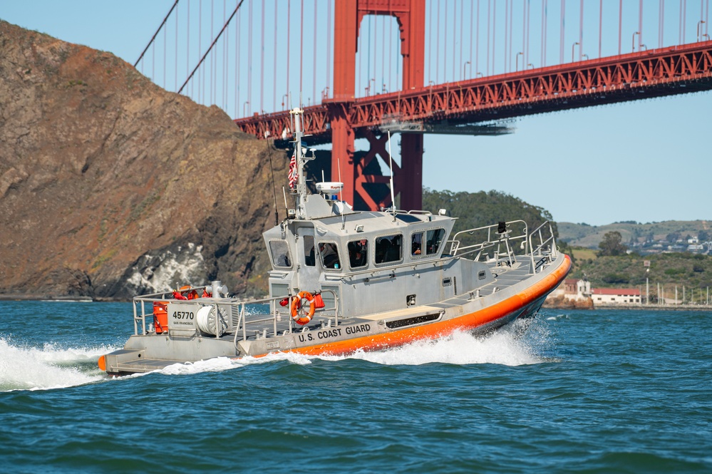 Coast Guard Bay Area assets pose for group photo with a 9/11 commemorative flag