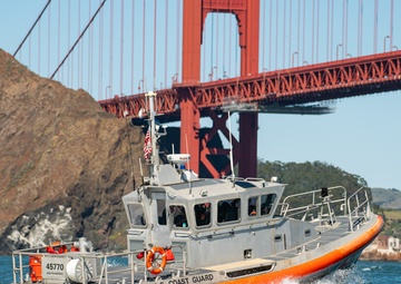 Coast Guard Bay Area assets pose for group photo with a 9/11 commemorative flag