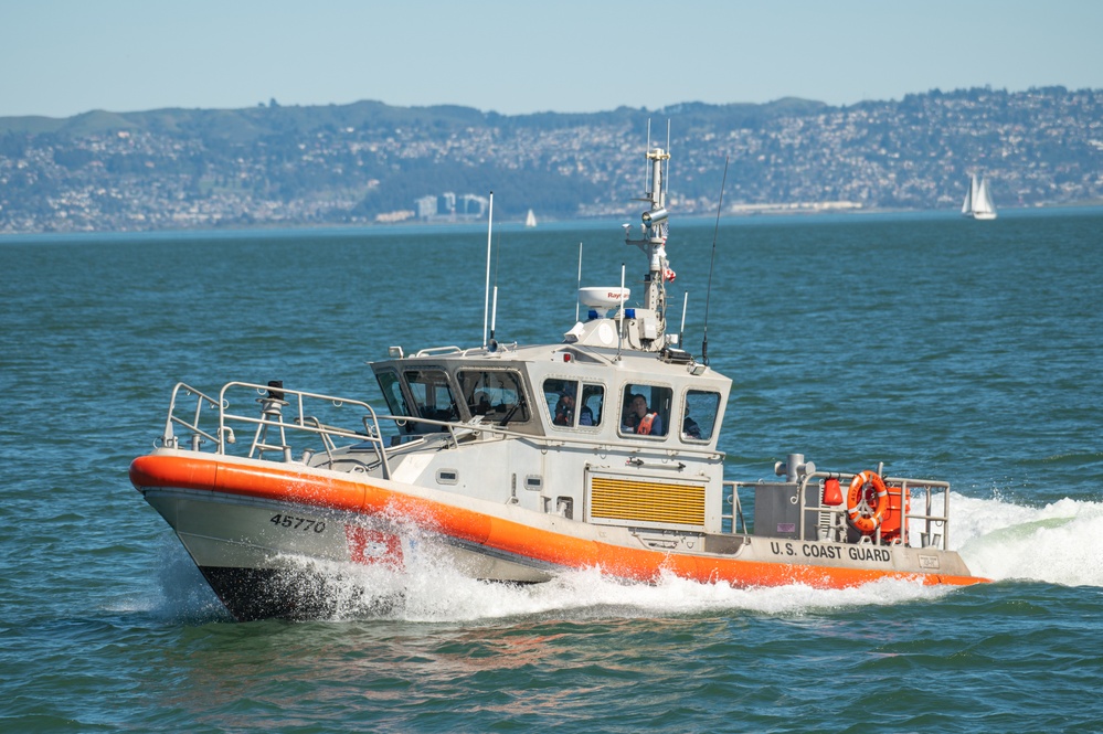 Coast Guard Bay Area assets pose for group photo with a 9/11 commemorative flag