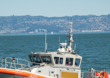 Coast Guard Bay Area assets pose for group photo with a 9/11 commemorative flag