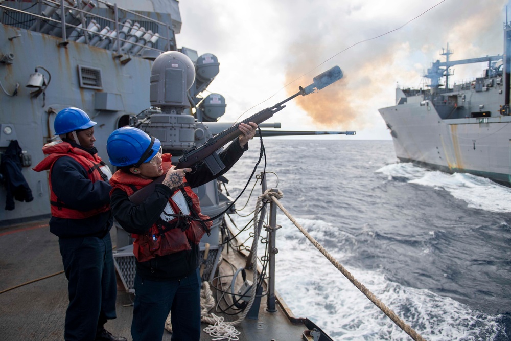 Gunner’s Mate 3rd Class Samantha Amadea, from Palmdale, Calif., fires a shot line