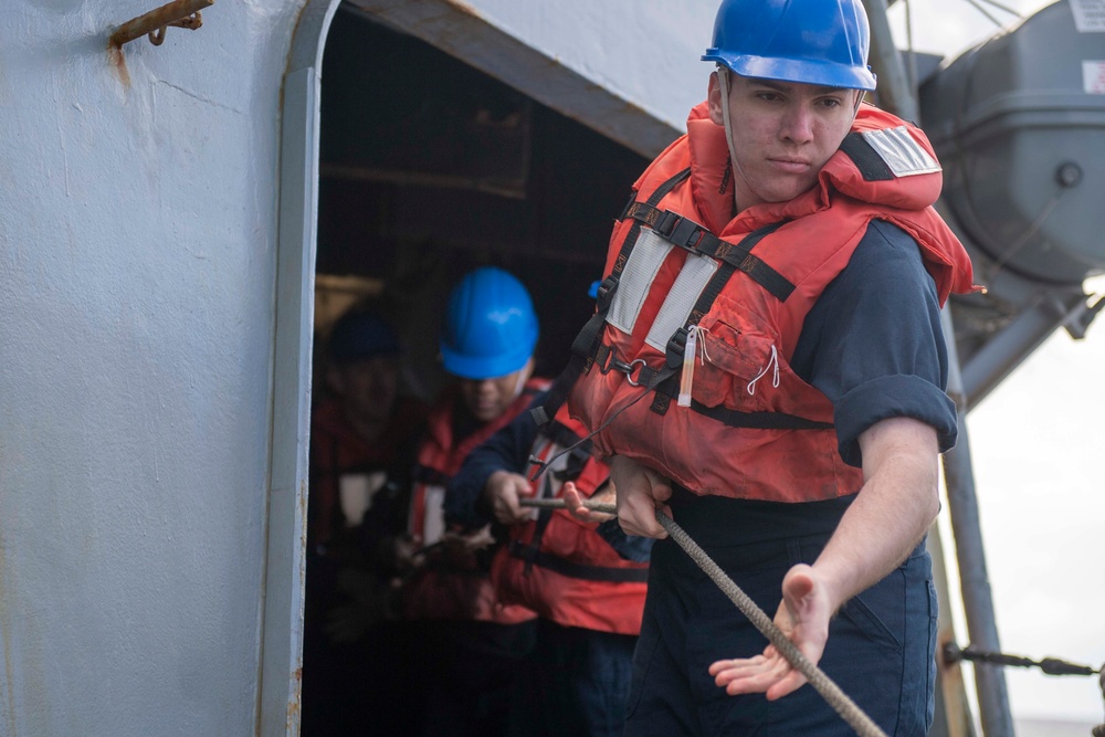 Fire Controlman (AEGIS) 3rd Class Tyler Carson, from Katy, Texas, heaves around on line