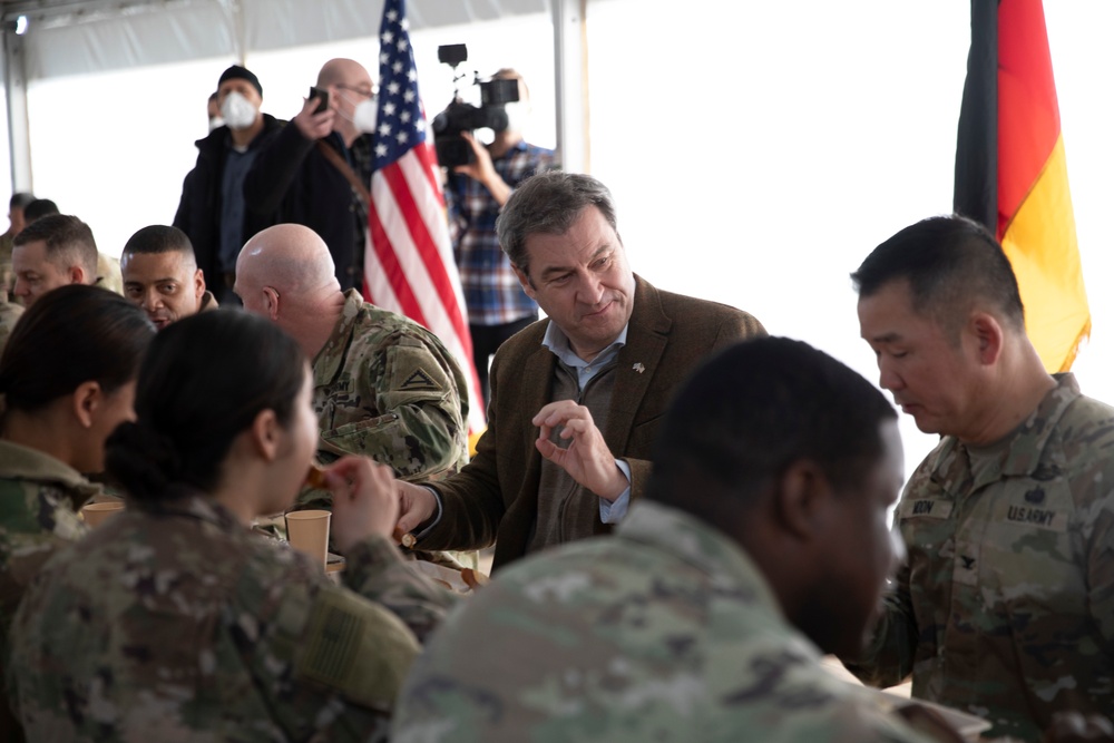 The Minister President of Bavaria, Markus Soeder, shares a meal with 1st Armored Brigade Combat Team, 3rd Infantry Division Soldiers