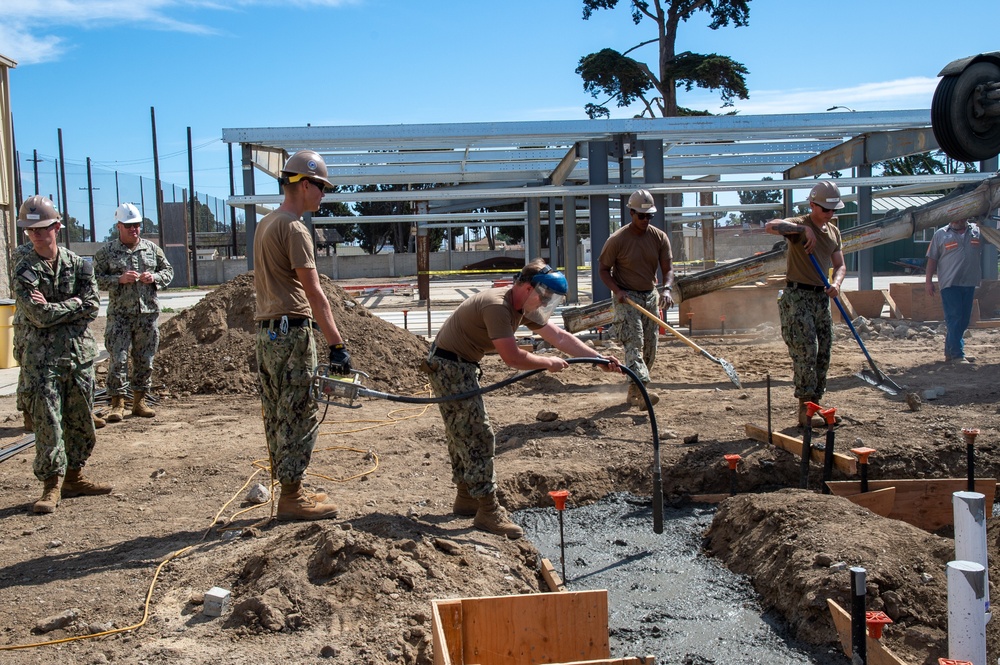 US Navy Seabees with NMCB-5 place concrete footers onboard Naval Base Ventura County