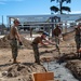 US Navy Seabees with NMCB-5 place concrete footers onboard Naval Base Ventura County