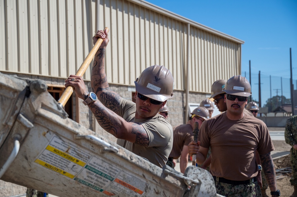 US Navy Seabees with NMCB-5 place concrete footers onboard Naval Base Ventura County