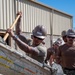 US Navy Seabees with NMCB-5 place concrete footers onboard Naval Base Ventura County