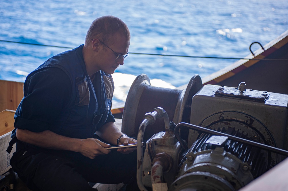 Sailor Repairs Replenishment-At-Sea Equipment