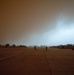 Iowa aviators walk flight line during dust storm at Camp Taji