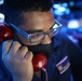 Ensign Brian Parham answers the phone as Combat Information Center Watch Officer onboard Arleigh-Burke class guided-missile destroyer USS Barry (DDG 52)
