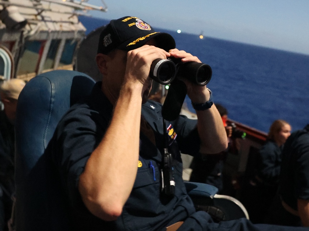 Cmdr. Bryan, USS Barry Commanding Officer, scans horizon