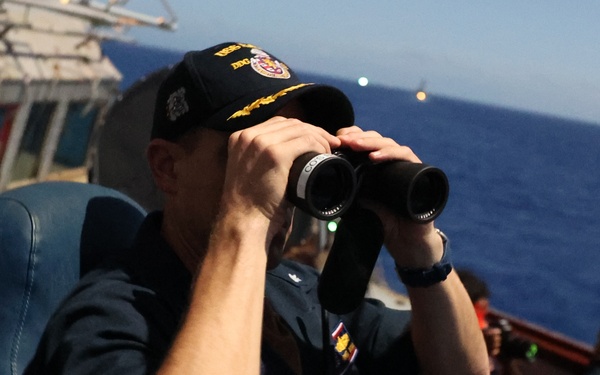 Cmdr. Bryan, USS Barry Commanding Officer, scans horizon