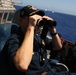 Cmdr. Bryan, USS Barry Commanding Officer, scans horizon